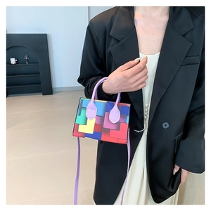Colorful geometric block handbag with purple round handle and adjustable shoulder strap