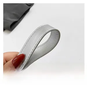 Detailed close-up of the silver-grey PU leather strap with precise stitching on crescent bag