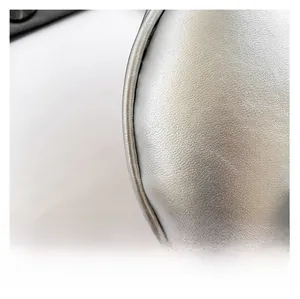 Macro shot of silver crescent bag showing lychee grain leather texture and stitching