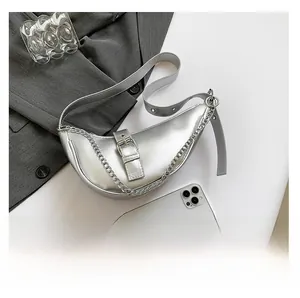 Top-down view of silver crescent bag with metallic leather finish and chain detail