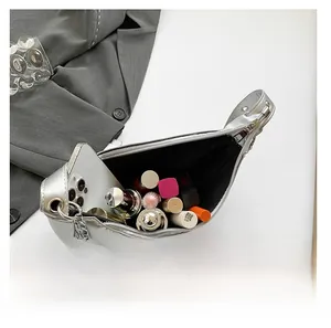 Internal view of a silver crescent bag showing spacious capacity for phone and makeup