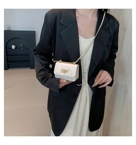 Mini white quilted leather crossbody bag with gold chain strap shown on model outfits