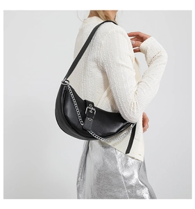 Close-up of black crescent underarm bag with silver chain strap and metal buckle