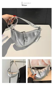 Detail view of silver crescent bag with metallic finish, adjustable strap and chain link