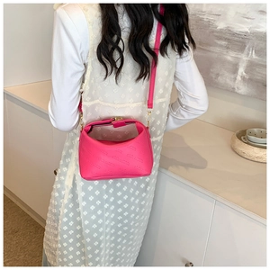Detail of fuchsia crossbody bag with CHCH embossed letters and gold metal hardware