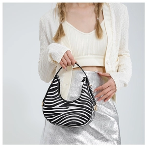 Fashionable zebra print half-moon underarm bag with gold hardware for trendy women