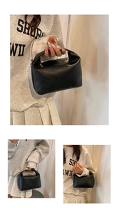 Detail of black pebbled leather cloud bag with rich rabbit embossing and gold zipper