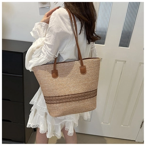 French straw tote bag with brown leather straps and vintage stripe detailing