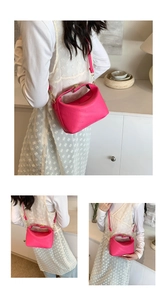 Detail view of fuchsia leather crossbody bag with rich rabbit embossed pattern textures