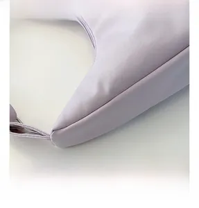 Detailed macro view of light purple woven canvas fabric and neat stitching of the bag