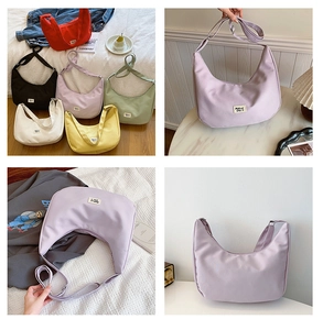 Detail of multi-color nylon dumpling bags with adjustable straps and zip closure