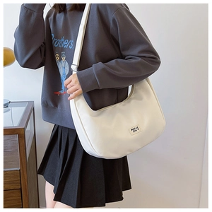 Detailed close-up of a white nylon crescent shoulder bag showing its smooth texture