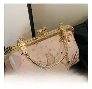 Detail of champagne sequin embroidery bag with gold ring handle and vintage metal clasp