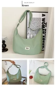 Detail view of light green nylon hobo bag featuring adjustable strap and woven label logo