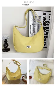 Close-up of yellow waterproof nylon hobo bag with adjustable strap and brand tag