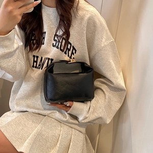 Chic black textured cloud bag with gold twist lock and rich rabbit pattern embossing