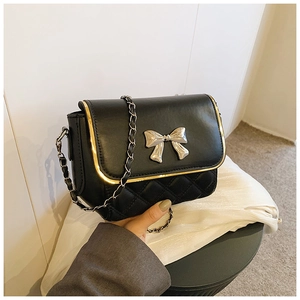 Quilted black crossbody bag with silver bow clasp and leather chain strap for women