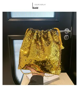 Close-up of gold sequin bucket bag with drawstring closure and tassel detail