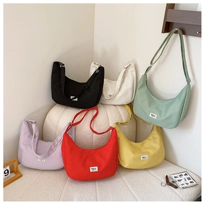 Colorful nylon crescent shoulder bags in multiple vibrant colors with adjustable straps