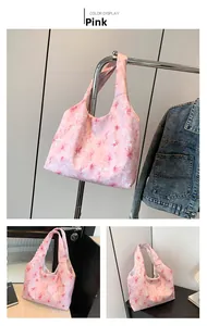 Close-up of pink floral canvas tote bag with white flower patterns and large capacity