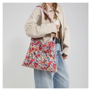 Floral canvas tote bag with colorful flower patterns and wide shoulder straps for women