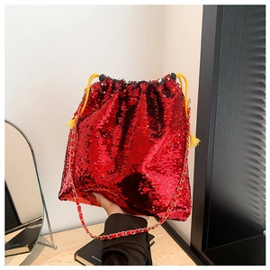 Sparkly red sequin bucket bag with gold chain strap and drawstring closure for women