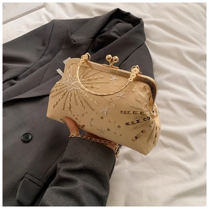 Close-up of champagne gold sequined evening bag with retro metal clasp and chain