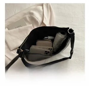 Internal view of large capacity black PU saddle bag showing umbrella and phone storage