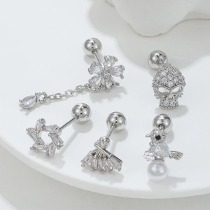 Set of five silver zircon ear studs with skull star and bird designs in bright white light