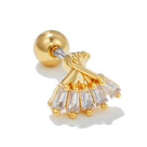 Macro shot of gold fan-shaped stud earring with baguette-cut zircons and round ball back