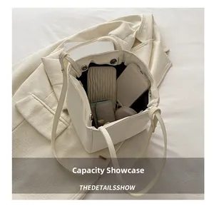 Top-down view of the spacious interior capacity of this minimalist cream white tote bag