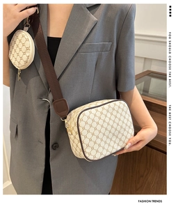 Detail of vintage monogram crossbody bag set with wide canvas strap and mini round pouch