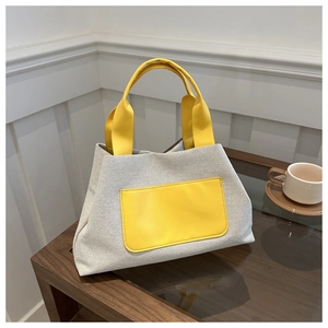 Stylish colorblock canvas tote bag with yellow leather handles for office commuting