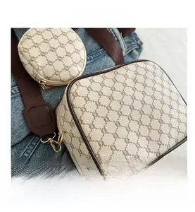 Detail view of vintage checkered crossbody bag set with gold hardware and wide strap