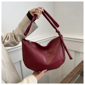 Burgundy semi-circle PU leather crossbody bag with knot shoulder strap and gold hardware