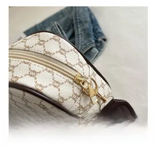 Macro detail of high-quality gold zipper and textured leather strap on checkered bag