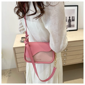Detail of pink two-tone crossbody bag featuring golden chain and JING PIN embossed text