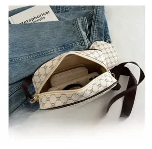 Macro view of the bag interior showing storage space for phone and wallet with wide strap