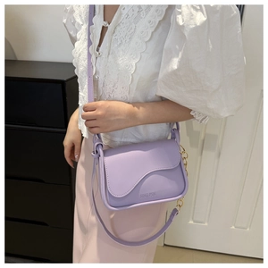 Close-up of purple faux leather saddle bag with gold chain and JING PIN embossed logo