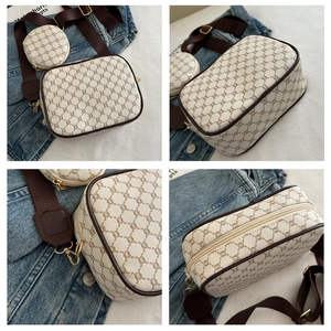 Detail view of the brown monogram crossbody bag with matching round coin purse and gold zip