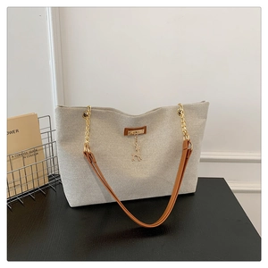 Retro beige woven tote bag with brown leather straps and deer charm detail