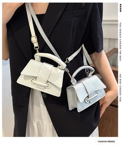 Close-up of mini square handbags in white and silver with lychee grain texture and top handles