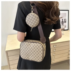 Detail of vintage plaid crossbody camera bag with mini round coin purse and wide strap