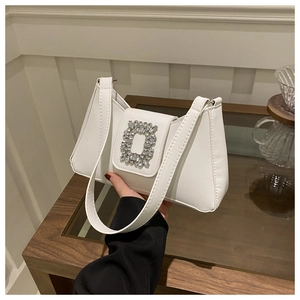 Detail of white PU leather underarm bag featuring a classic rectangular rhinestone buckle