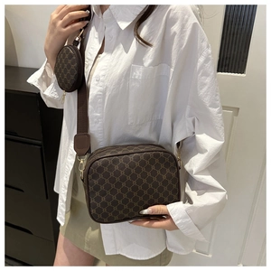 Detail of vintage monogram crossbody camera bag with adjustable strap and coin purse