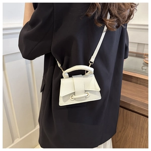 White mini handbag detail with lychee grain leather and stylish metal ring closure