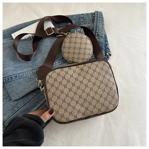 Close-up of vintage monogram crossbody bag with small round coin pouch on nylon strap
