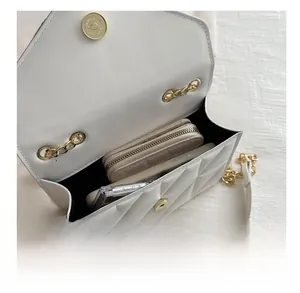 Interior storage space of the white quilted chain bag showing capacity for daily items