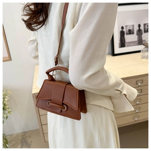 Detailed back view of a brown pebbled leather mini square bag with versatile straps