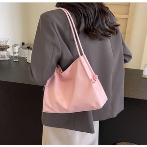 Detailed back view of a soft pink PU bucket bag with side knot accents and slim straps
